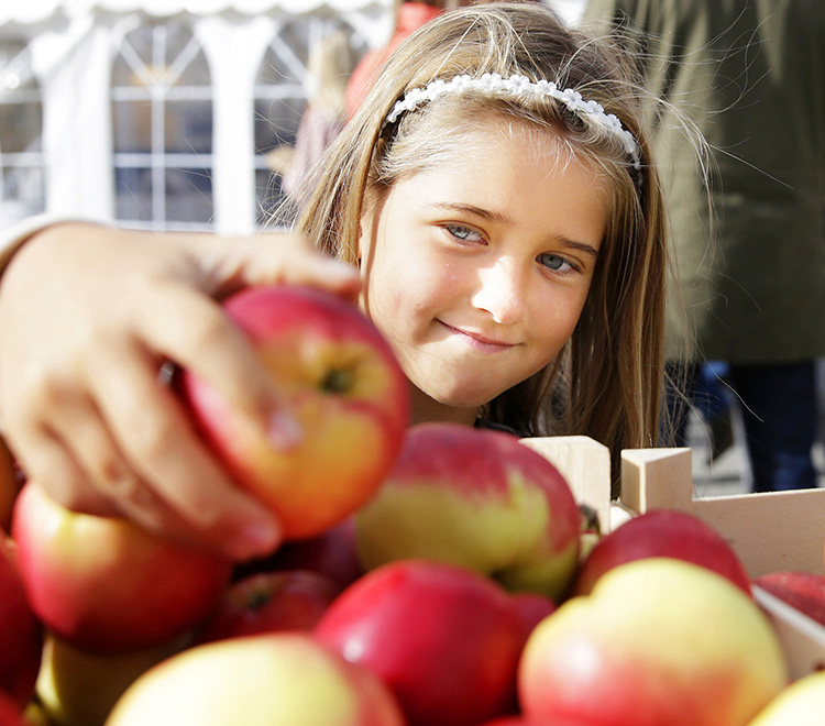 Girls grabbing an apple