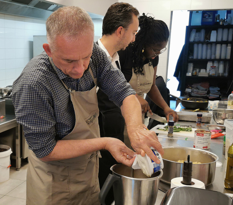 People cooking in community kitchen