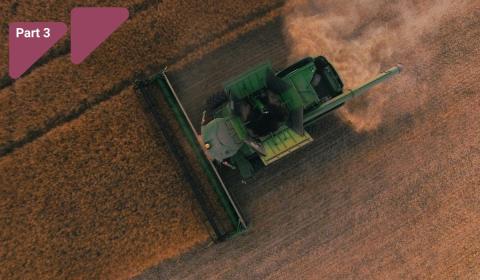 Image showing a green tractor driving through a field